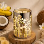 Decorative candle holder with floral design on a wooden surface with bananas and coconuts in the background.