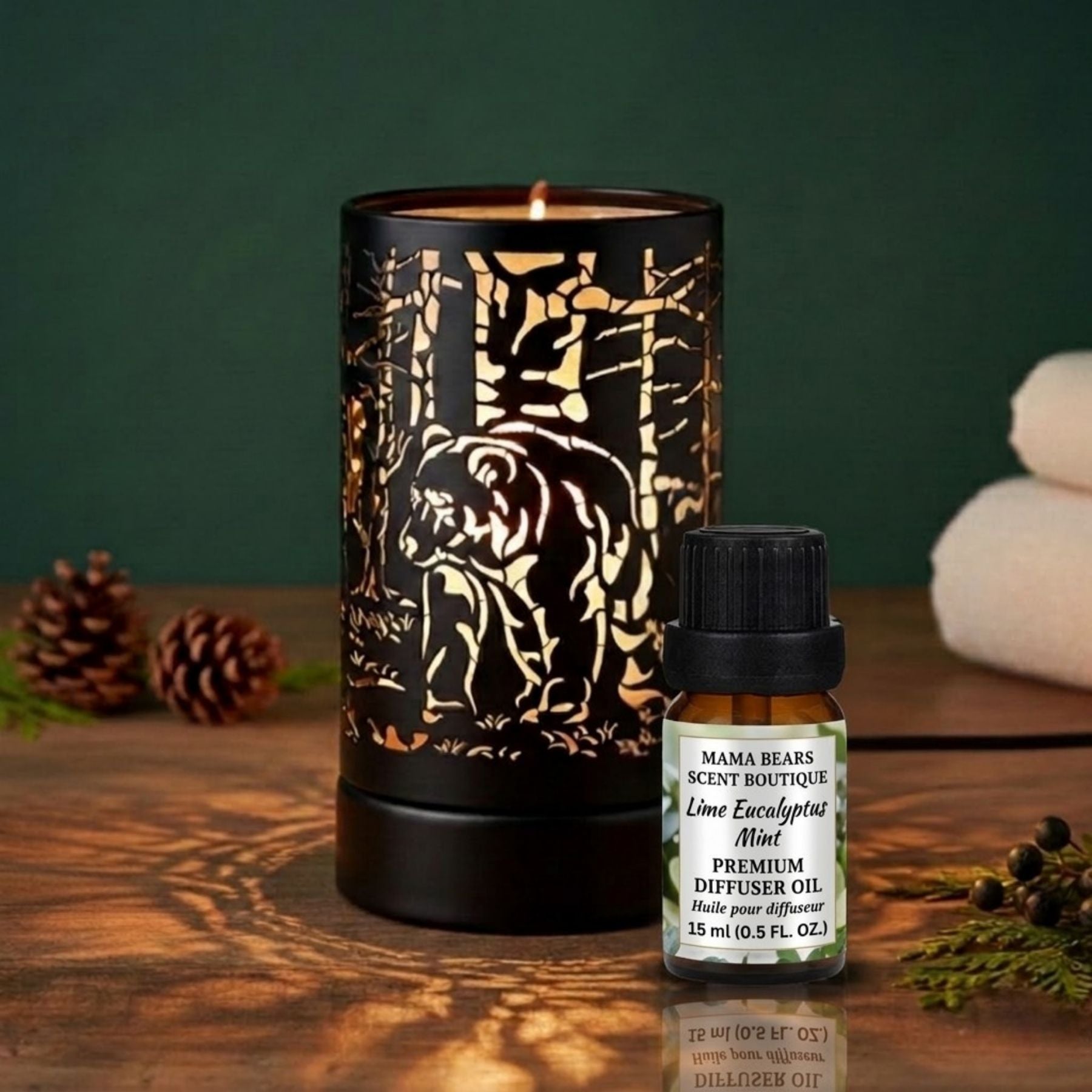 Diffuser oil/wax warmer and diffuser oil bottle on a wooden surface with a green background