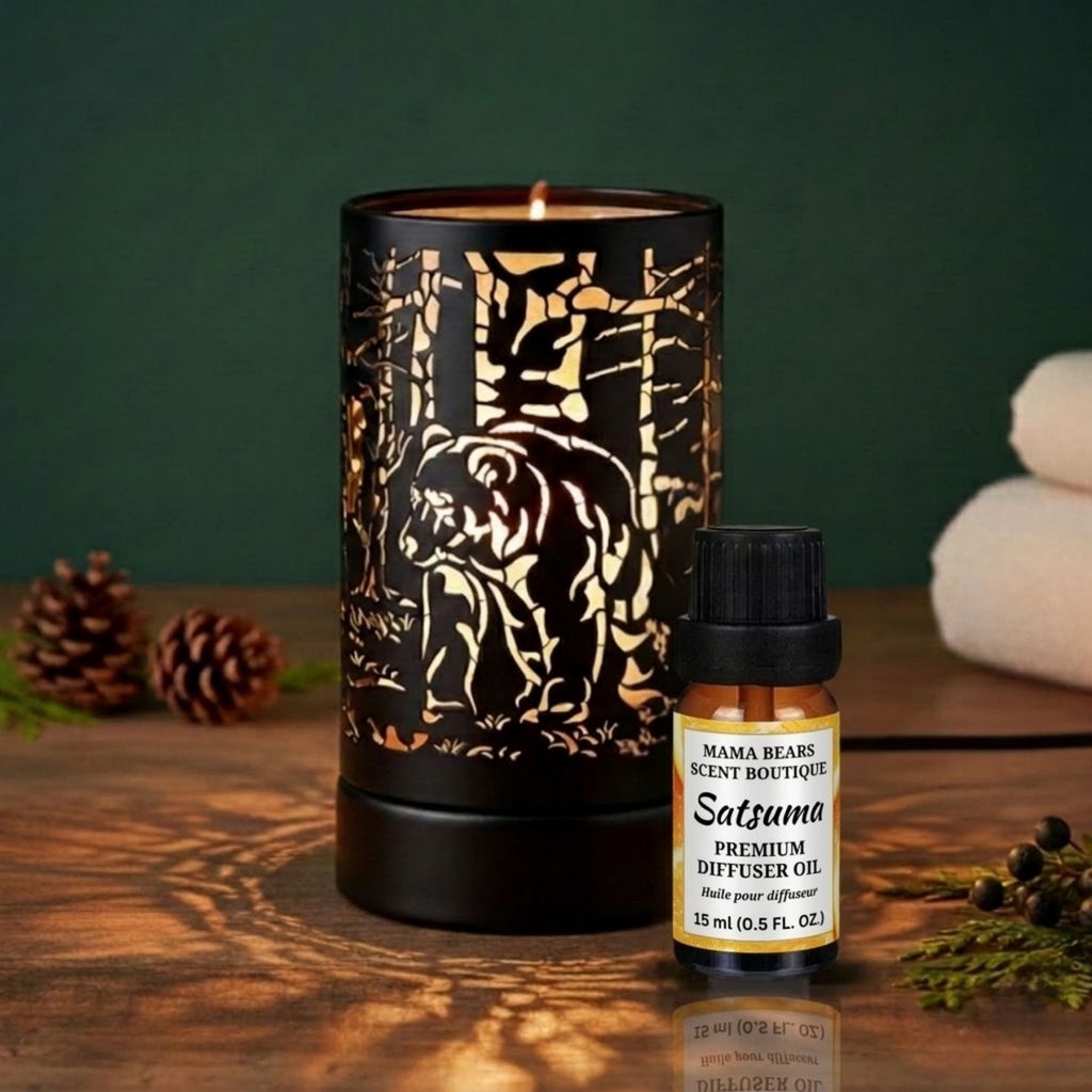 A candle/wax melt warmer with a bottle of Satsuma diffuser oil on a wooden surface.