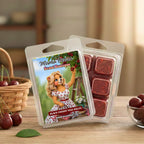 Mama Bear's Scent Boutique Black Cherry wax melts packaging on a wooden surface with cherries and a basket in the background.