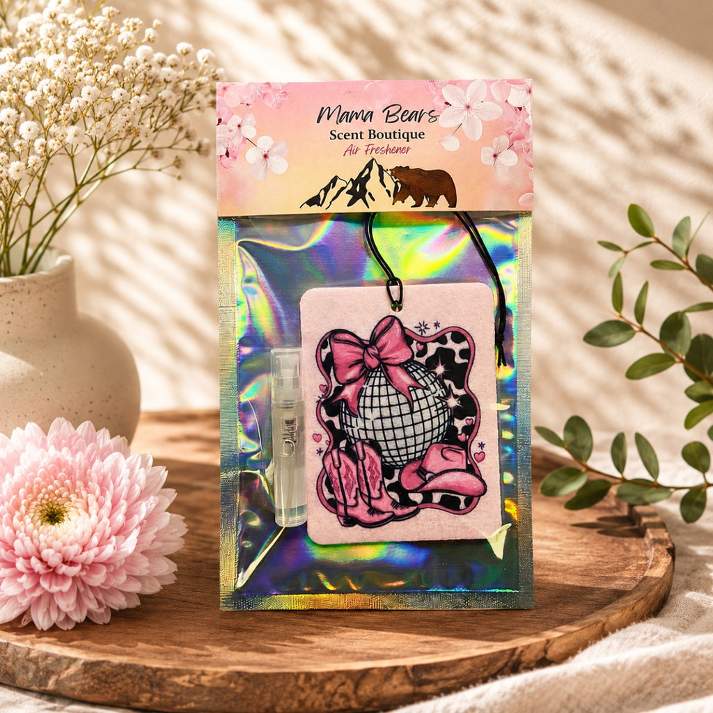 Mama Bear's Scent Boutique air freshener packaging with decorative elements on a wooden surface.