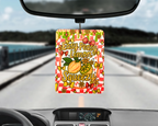 Car air freshener with lemon design hanging from a car's rearview mirror.
