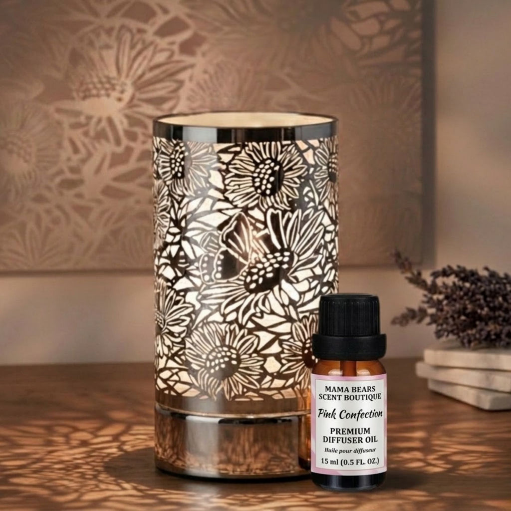 Diffuser oil/wax warmer with floral patterns and a bottle of diffuser oil on a wooden surface.