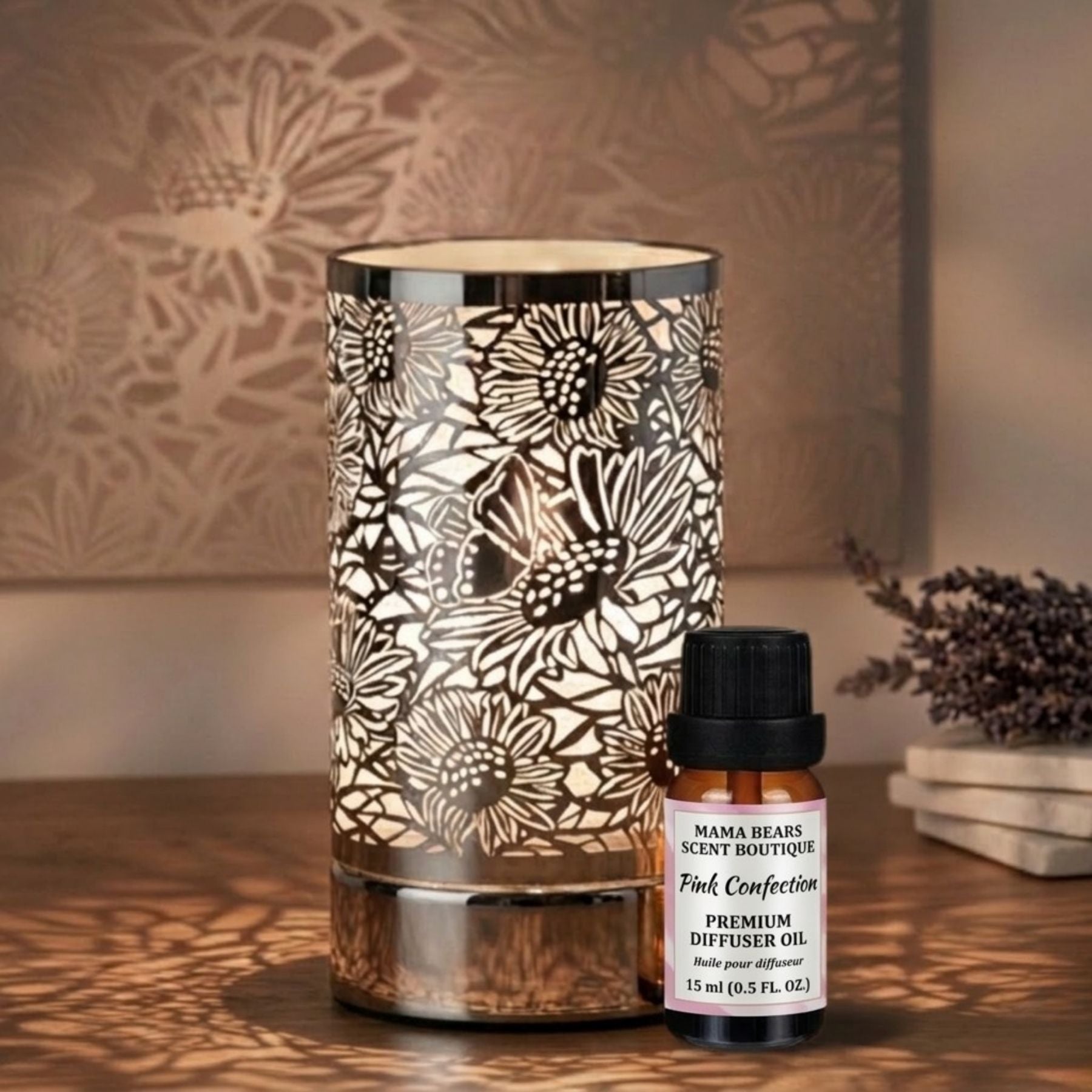 Diffuser oil/wax warmer with floral patterns and a bottle of diffuser oil on a wooden surface.