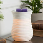 Grape Soda Pop styled in a white wax warmer that has a wavy line pattern on it.