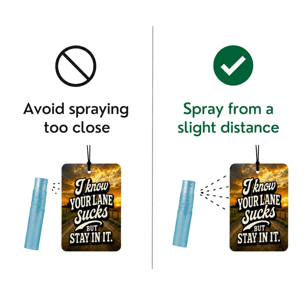 Instruction graphic showing two sides of using an air freshener spray: on the left, avoid spraying too close with a red prohibition symbol and text; on the right, spray from a slight distance with a green checkmark and text. The product includes a rectangular printed tag with a sunset road scene and the phrase 'I know YOUR LANE sucks BUT stay in it.
