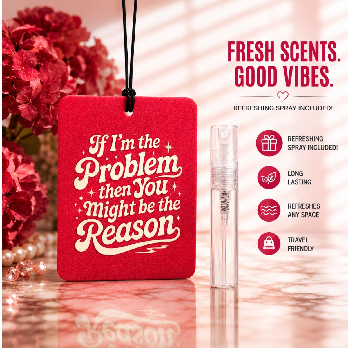 Pink air freshener with motivational quote and refreshing spray on a reflective surface with flowers in the background