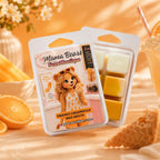 Mama Bears Scent Boutique Orange Creamsicle wax melts packaging with wax melts visible, surrounded by oranges and flowers.