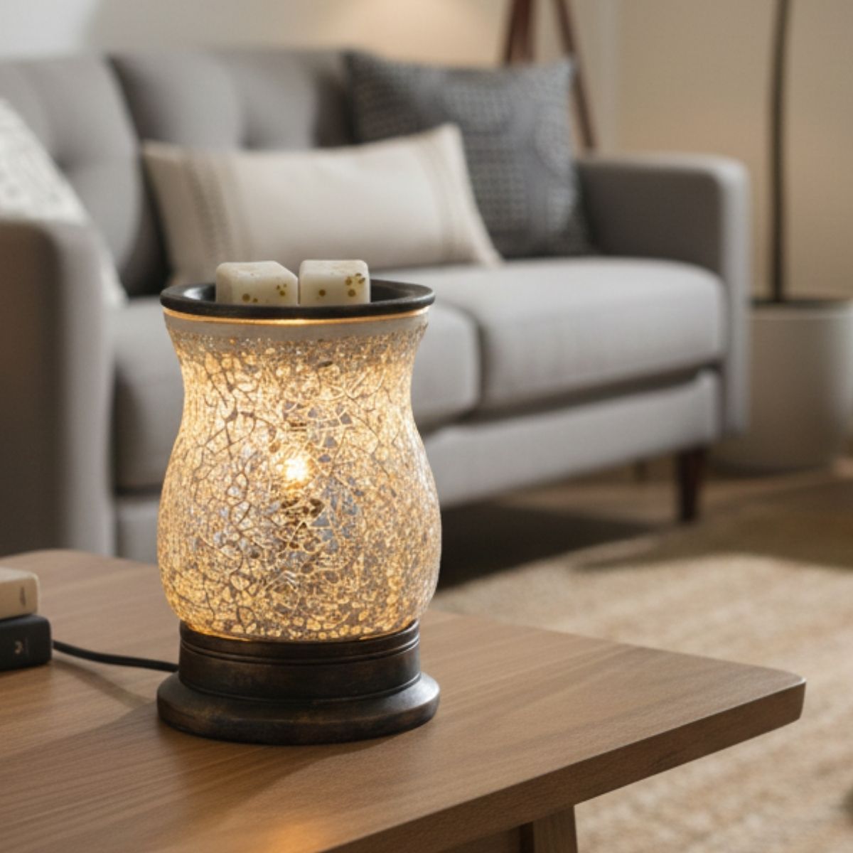 Mosaic-patterned wax melt warmer with Parfum No. 5 wax melt cubes in it. It is on on a wooden table with a blurred living room background