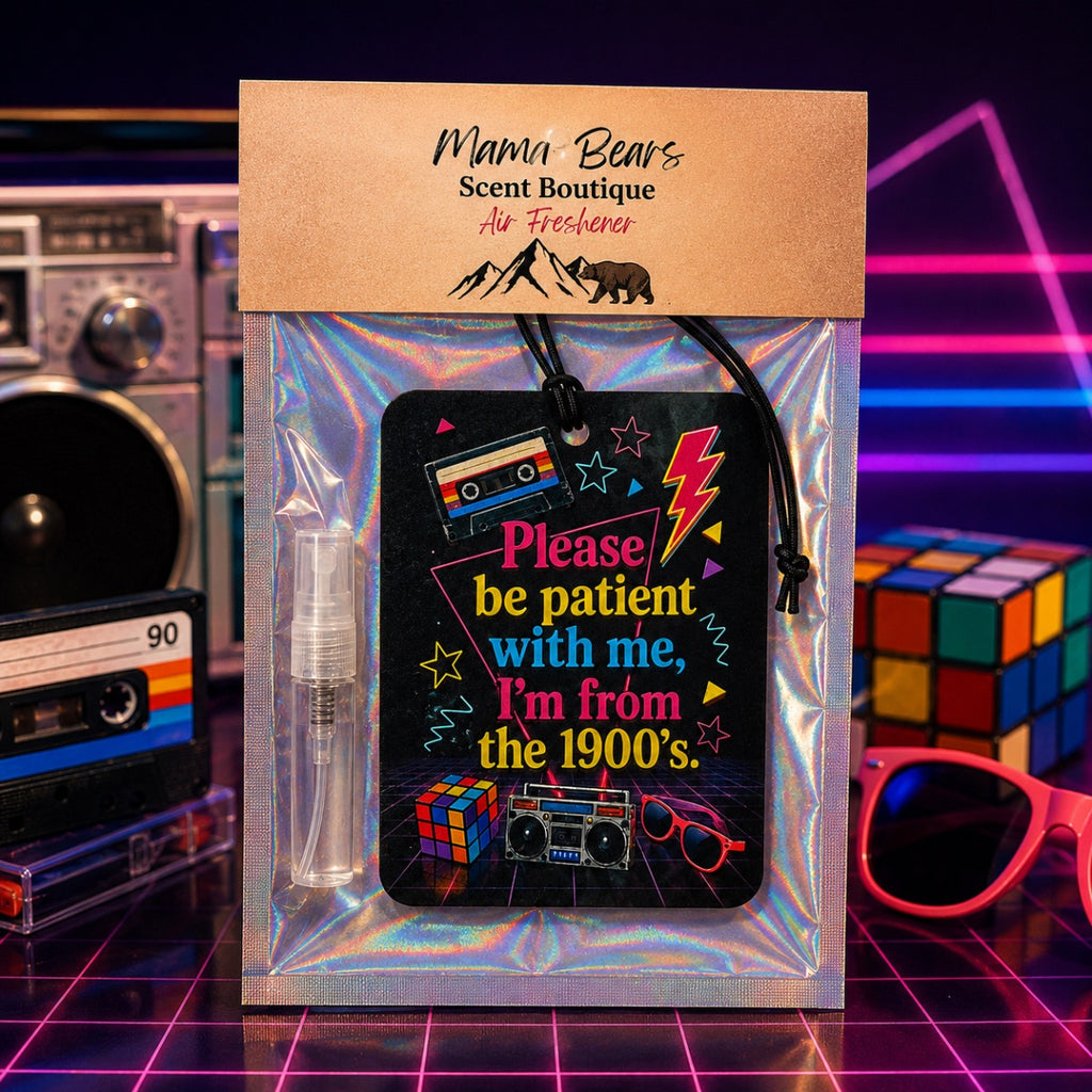 A packaged air freshener from Mama Bears Scent Boutique, featuring a retro 1990s-themed black card with colorful text and graphics, a clear spray bottle, and a kraft paper header card, displayed against a neon grid background with vintage electronics and a Rubik's cube.