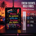 A retro-themed car air freshener spray with a clear spray bottle, set against a sunset road scene with palm trees. The tag features a black background with colorful 1990s graphics, including a cassette tape, boombox, Rubik's cube, and sunglasses, with the text 'Please be patient with me, I'm from the 1900's.