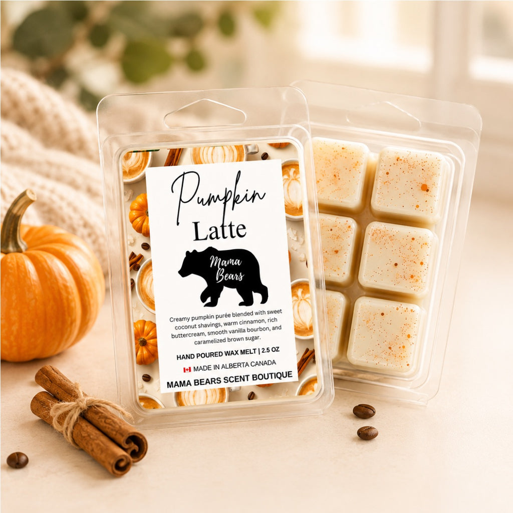Two clear plastic wax melts packages labeled 'Pumpkin Latte' by Mama Bears, shown on a light tabletop with a small pumpkin, cinnamon sticks, and coffee beans. The front package contains a white label with a black bear logo and scent details, while the rear package shows the cream-colored wax melts inside.