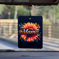 A felt air freshener hanging from a rear view mirror that has a picture of a sunflower on it and says the word Mama in the middle.